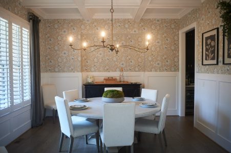 Dining room with gray wallpaper, board-and-batten and lantern chandelier