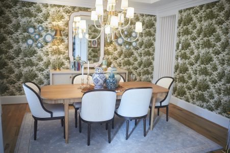 Dining room with bold green botanical wallpaper and round table