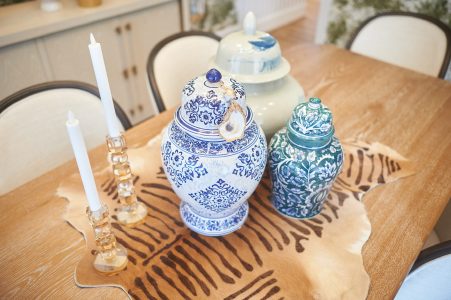 Dining table styled with blue ginger jars and a zebra-print runner