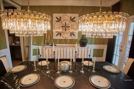 Formal dining table with layered place settings and patterned rug
