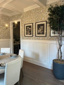 Foyer with board-and-batten, framed gallery wall and tall planter