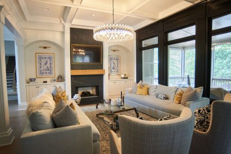 Great room with layered blue sofas and fireplace