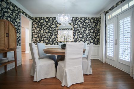 Great room with twin blue sofas, fireplace and coffered ceiling