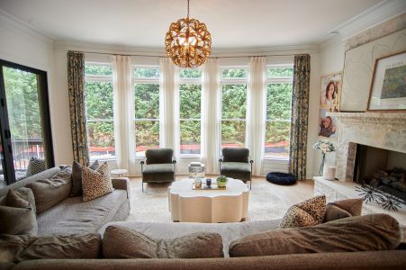 Living room with curved gray sectional and bay window