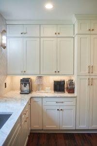White kitchen with tall cabinetry and built-in coffee station